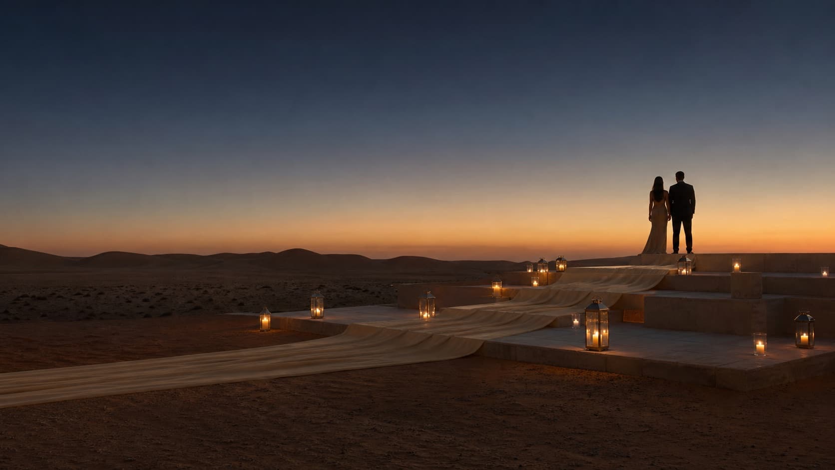A couple silhouetted above an Egyptian desert celebration
